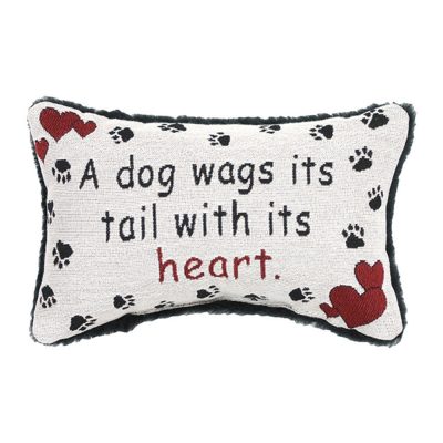 A dog wags its tail with its heart pillow