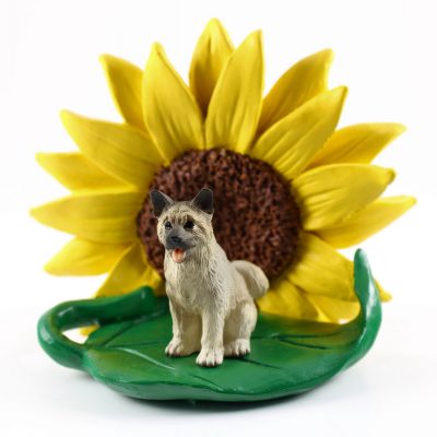 Akita Gray Figurine Sitting on a Green Leaf in Front of a Yellow Sunflower