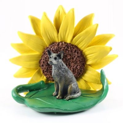 Australian Cattle Dog Blue Figurine Sitting on a Green Leaf in Front of a Yellow Sunflower