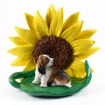 Basset Hound Figurine Sitting on a Green Leaf in Front of a Yellow Sunflower