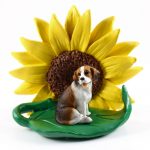 Beagle Figurine Sitting on a Green Leaf in Front of a Yellow Sunflower