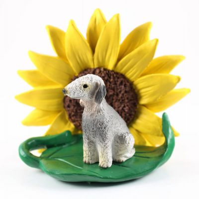 Bedlington Terrier Figurine Sitting on a Green Leaf in Front of a Yellow Sunflower