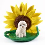 Bichon Frise Figurine Sitting on a Green Leaf in Front of a Yellow Sunflower