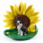 Boston Terrier Figurine Sitting on a Green Leaf in Front of a Yellow Sunflower