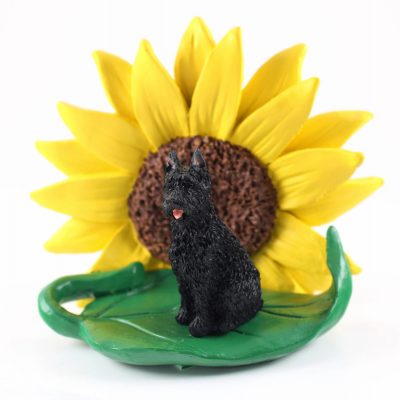 Bouvier Figurine Sitting on a Green Leaf in Front of a Yellow Sunflower