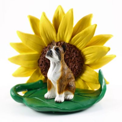 Boxer Brindle Figurine Sitting on a Green Leaf in Front of a Yellow Sunflower