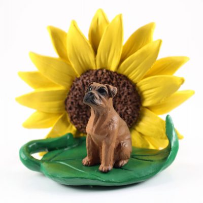 Boxer Tawny Uncropped Figurine Sitting on a Green Leaf in Front of a Yellow Sunflower