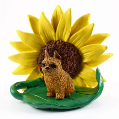 Brussels Griffon Red Figurine Sitting on a Green Leaf in Front of a Yellow Sunflower