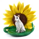 Bull Terrier White Figurine Sitting on a Green Leaf in Front of a Yellow Sunflower