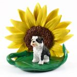 Bulldog Brindle Figurine Sitting on a Green Leaf in Front of a Yellow Sunflower