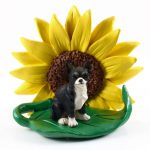 Chihuahua Black Figurine Sitting on a Green Leaf in Front of a Yellow Sunflower