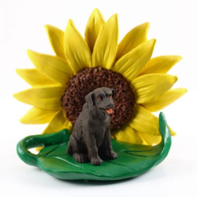Chocolate Lab Figurine Sitting on a Green Leaf in Front of a Yellow Sunflower