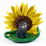 Chow Chow Blue Figurine Sitting on a Green Leaf in Front of a Yellow Sunflower