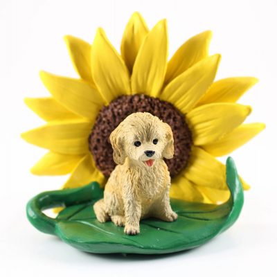 Cockapoo Blonde Figurine Sitting on a Green Leaf in Front of a Yellow Sunflower