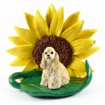 Cocker Spaniel Blonde Figurine Sitting on a Green Leaf in Front of a Yellow Sunflower