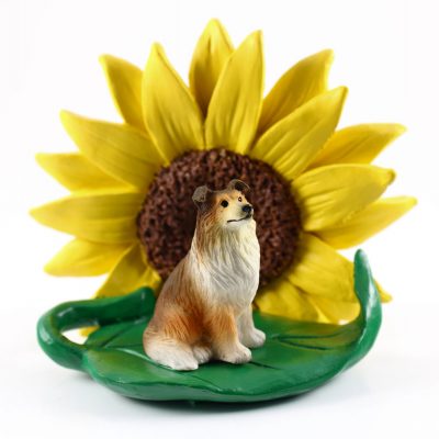 Collie Sable Figurine Sitting on a Green Leaf in Front of a Yellow Sunflower