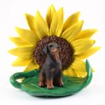 Doberman Pinscher Red Uncropped Figurine Sitting on a Green Leaf in Front of a Yellow Sunflower
