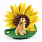 English Cocker Spaniel Blonde Figurine Sitting on a Green Leaf in Front of a Yellow Sunflower