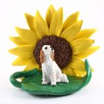 English Setter Orange Figurine Sitting on a Green Leaf in Front of a Yellow Sunflower