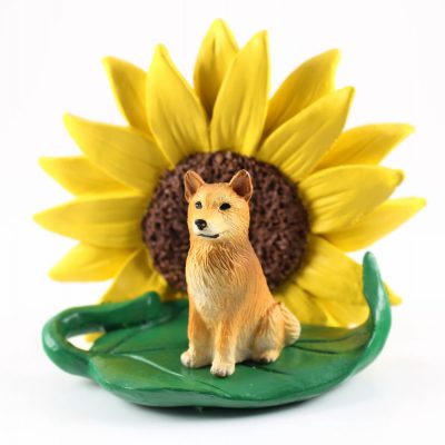 Finnish Spitz Figurine Sitting on a Green Leaf in Front of a Yellow Sunflower