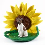 Fox Terrier Brown Figurine Sitting on a Green Leaf in Front of a Yellow Sunflower