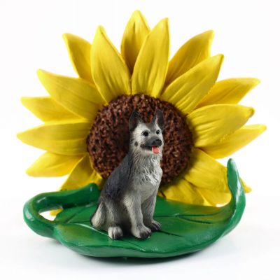 German Shepherd Black/Silver Figurine Sitting on a Green Leaf in Front of a Yellow Sunflower