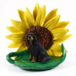 Gordon Setter Figurine Sitting on a Green Leaf in Front of a Yellow Sunflower