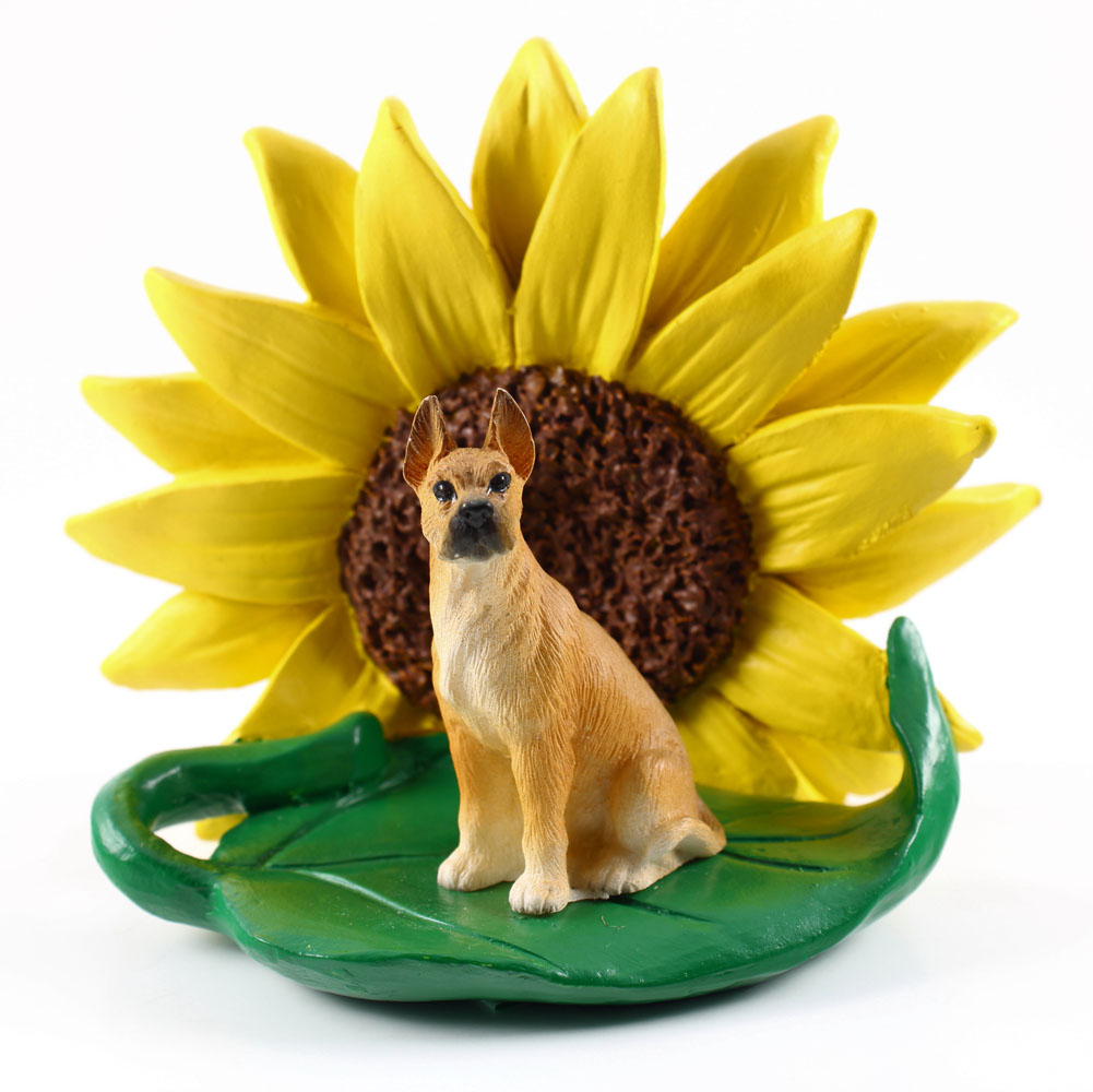 Great Dane Fawn Figurine Sitting on a Green Leaf in Front of a Yellow Sunflower