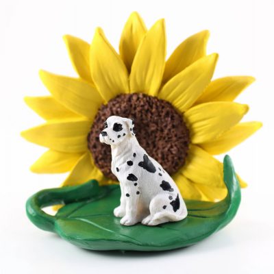Great Dane Harlequin Uncropped Figurine Sitting on a Green Leaf in Front of a Yellow Sunflower