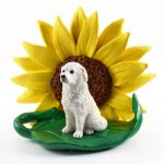 Great Pyrenees Figurine Sitting on a Green Leaf in Front of a Yellow Sunflower