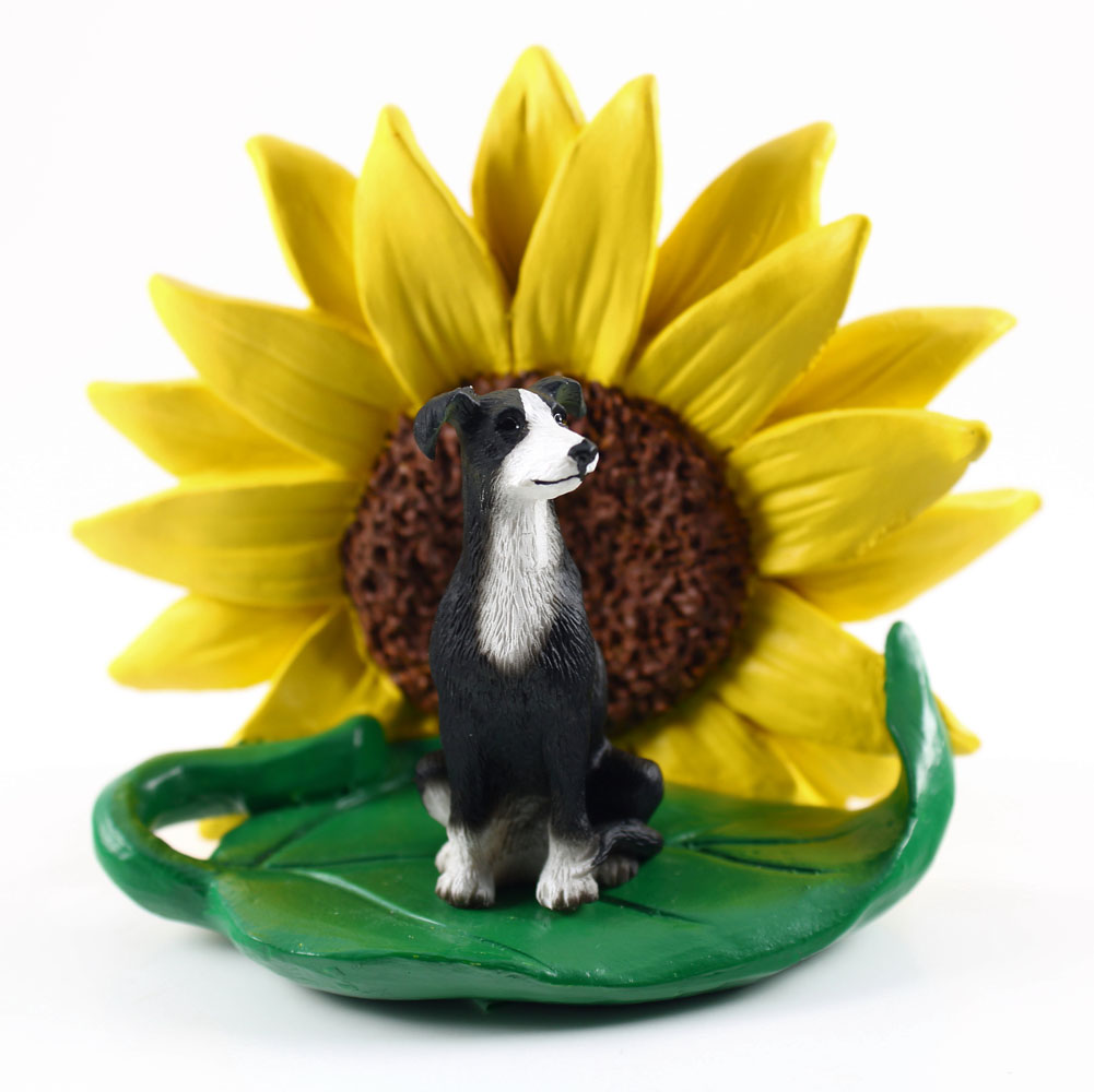 Greyhound Black/White Figurine Sitting on a Green Leaf in Front of a Yellow Sunflower