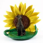 Greyhound Brindle Figurine Sitting on a Green Leaf in Front of a Yellow Sunflower