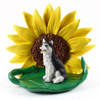Husky Black/White Blue Eyes Figurine Sitting on a Green Leaf in Front of a Yellow Sunflower