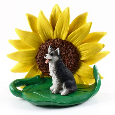 Husky Black/White Brown Eyes Figurine Sitting on a Green Leaf in Front of a Yellow Sunflower