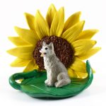 Husky Gray/White Brown Eyes Figurine Sitting on a Green Leaf in Front of a Yellow Sunflower