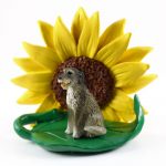 Irish Wolfhound Figurine Sitting on a Green Leaf in Front of a Yellow Sunflower