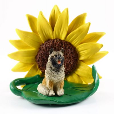 Keeshond Figurine Sitting on a Green Leaf in Front of a Yellow Sunflower