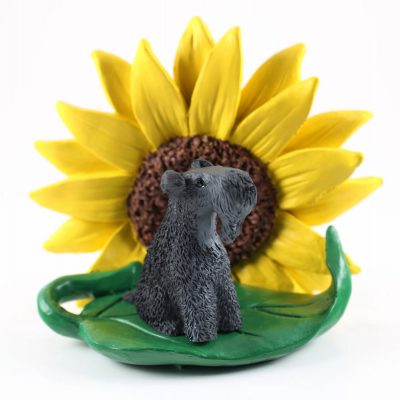 Kerry Blue Terrier Figurine Sitting on a Green Leaf in Front of a Yellow Sunflower