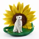 Kuvasz Figurine Sitting on a Green Leaf in Front of a Yellow Sunflower