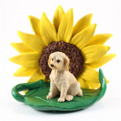Labradoodle Blonde Figurine Sitting on a Green Leaf in Front of a Yellow Sunflower