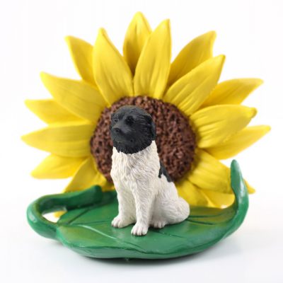 Landseer Figurine Sitting on a Green Leaf in Front of a Yellow Sunflower
