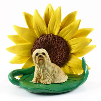Llhasa Apso Blonde Figurine Sitting on a Green Leaf in Front of a Yellow Sunflower