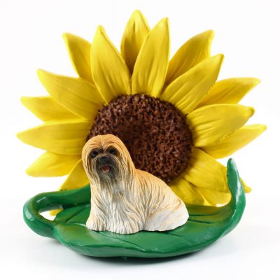 Llhasa Apso Brown Figurine Sitting on a Green Leaf in Front of a Yellow Sunflower