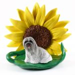 Llhasa Apso Gray Figurine Sitting on a Green Leaf in Front of a Yellow Sunflower