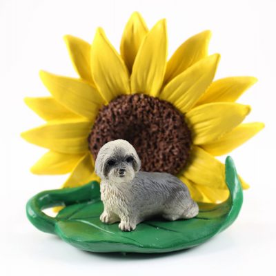 Llhasa Apso Gray Puppy Cut Figurine Sitting on a Green Leaf in Front of a Yellow Sunflower