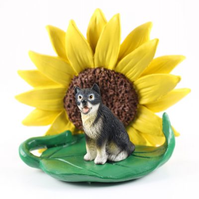 Malamute Figurine Sitting on a Green Leaf in Front of a Yellow Sunflower