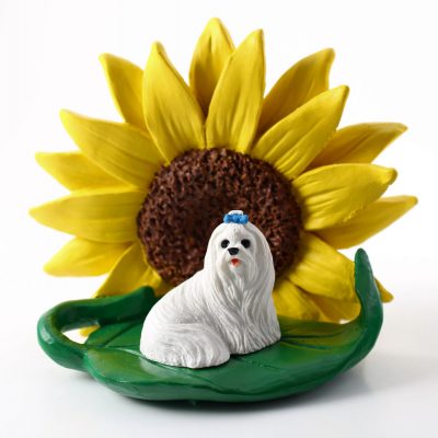 Maltese Figurine Sitting on a Green Leaf in Front of a Yellow Sunflower