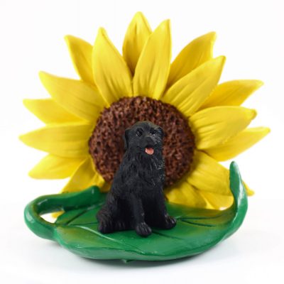 Newfoundland Figurine Sitting on a Green Leaf in Front of a Yellow Sunflower