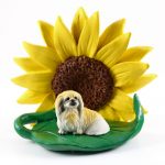 Pekingese Figurine Sitting on a Green Leaf in Front of a Yellow Sunflower
