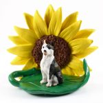 Pitbull Brindle Figurine Sitting on a Green Leaf in Front of a Yellow Sunflower